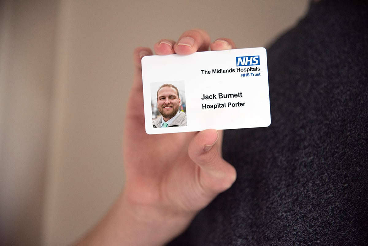 NHS ID card sample in hand